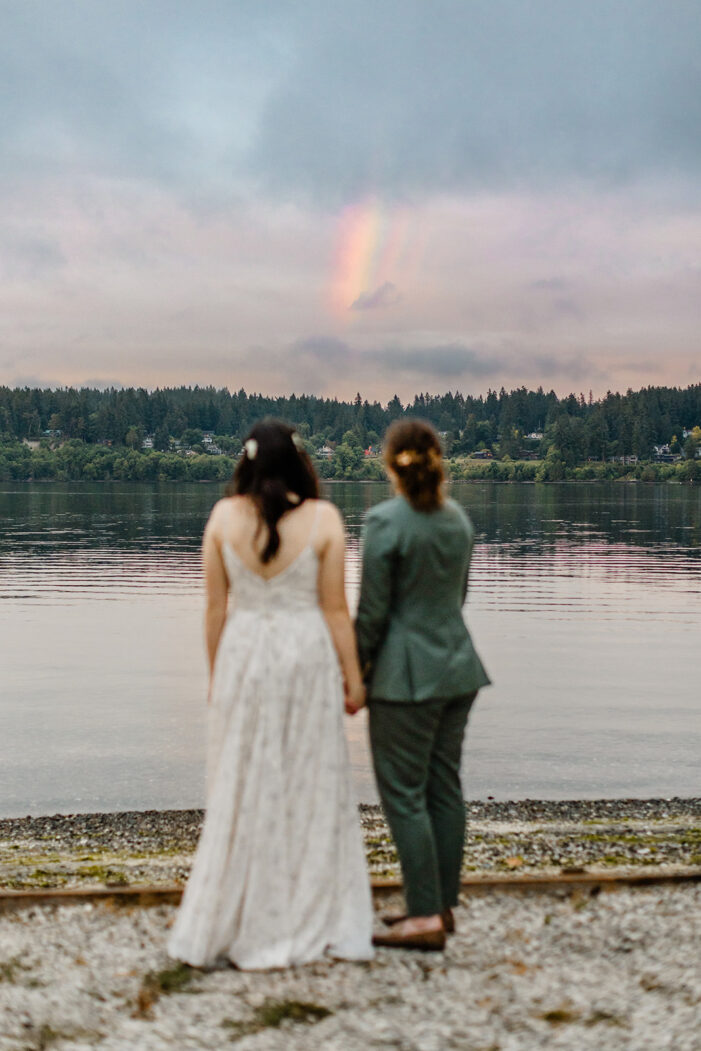 two brides look out at the water together