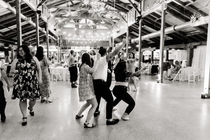 brides dance with guests at wedding