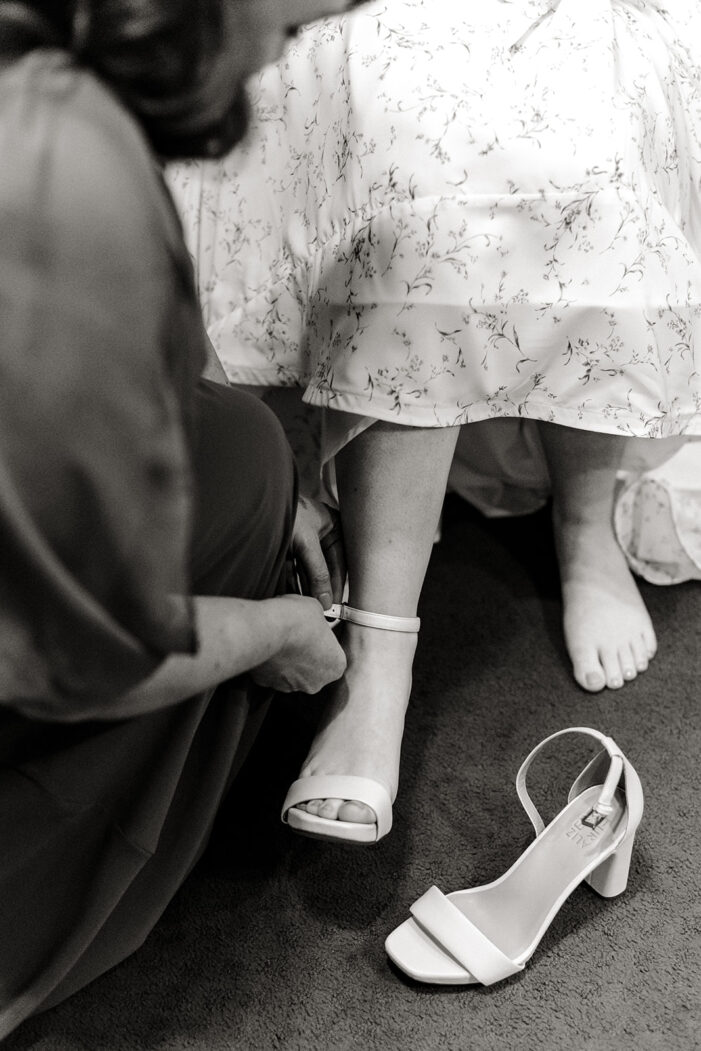shoes being put on bride