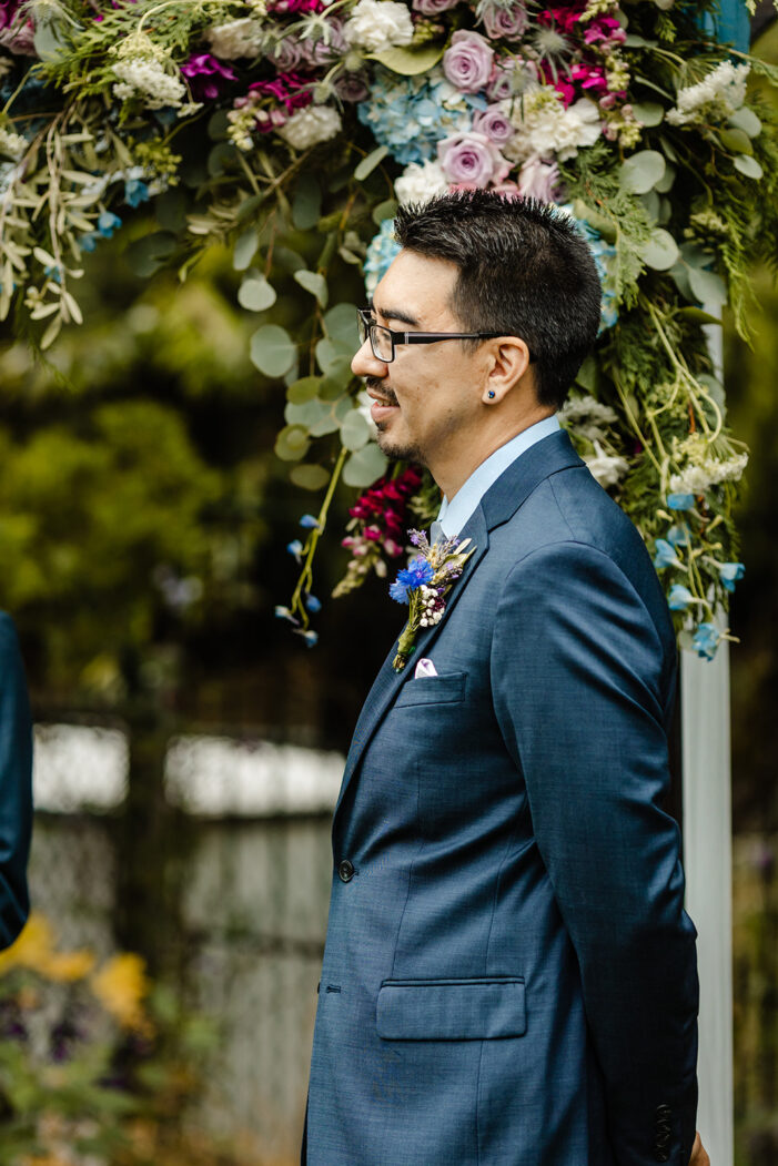 groom looks at bride during ceremony