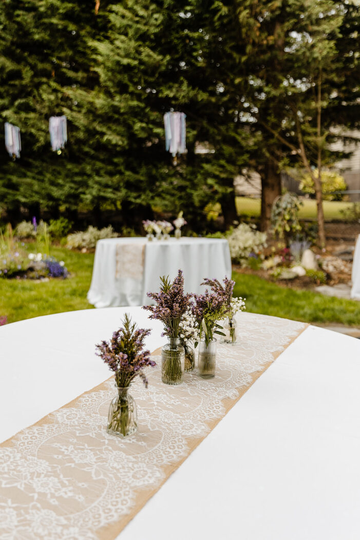 lavender in glass vases on white table cloths