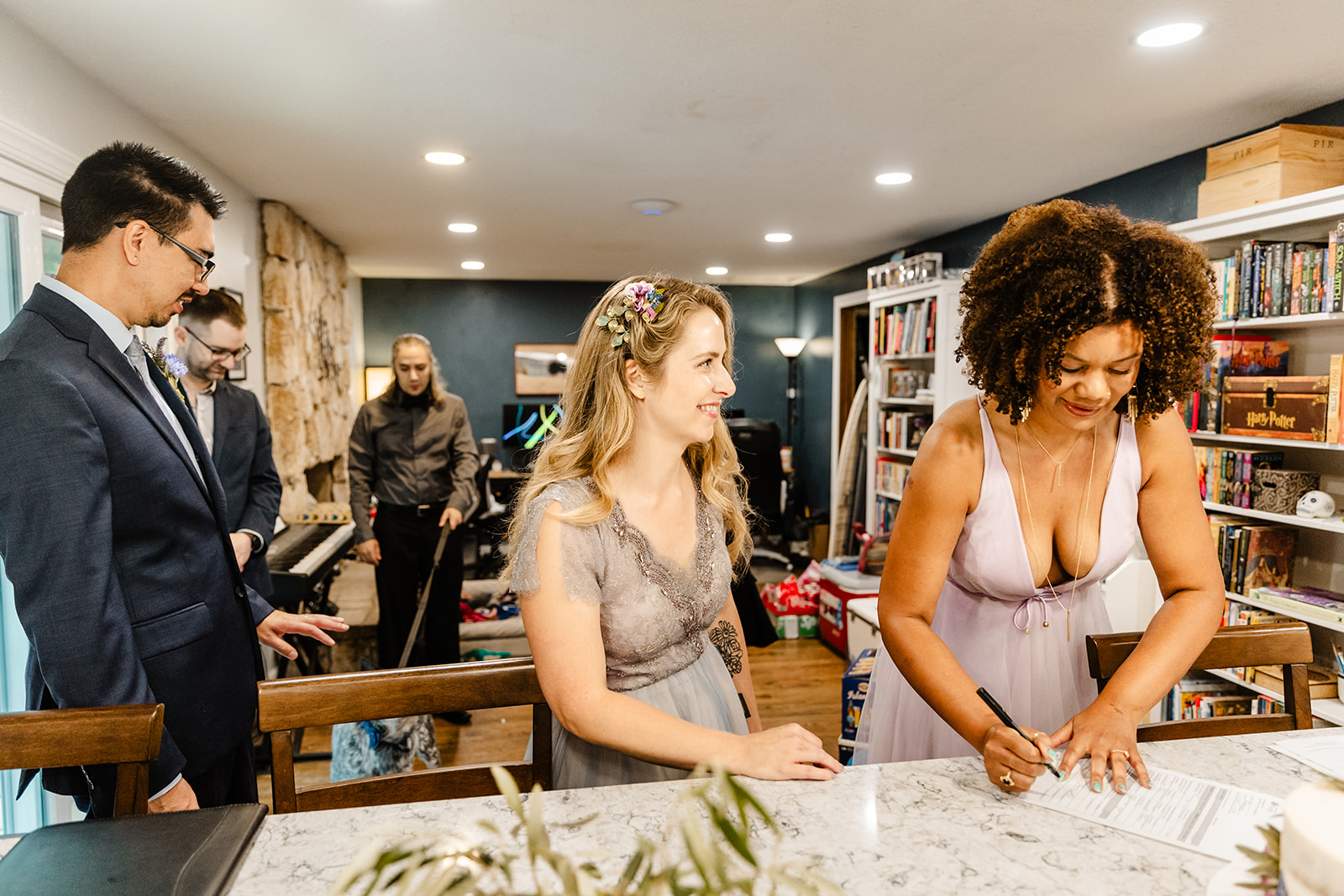 bride and witnesses sign marriage license