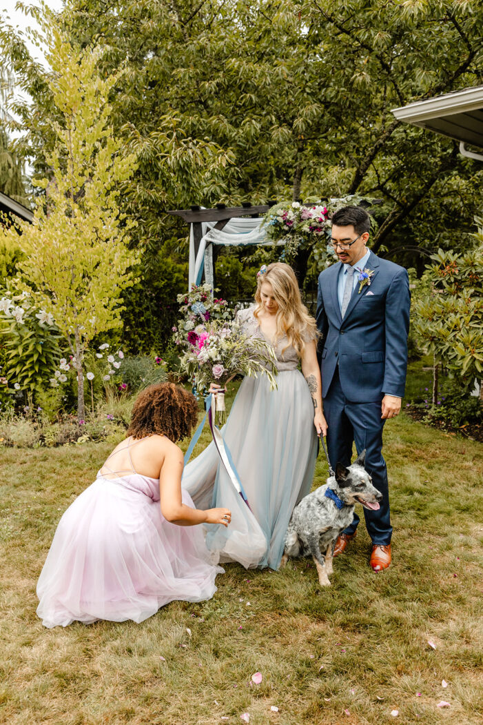 bride and groom pose with their pup