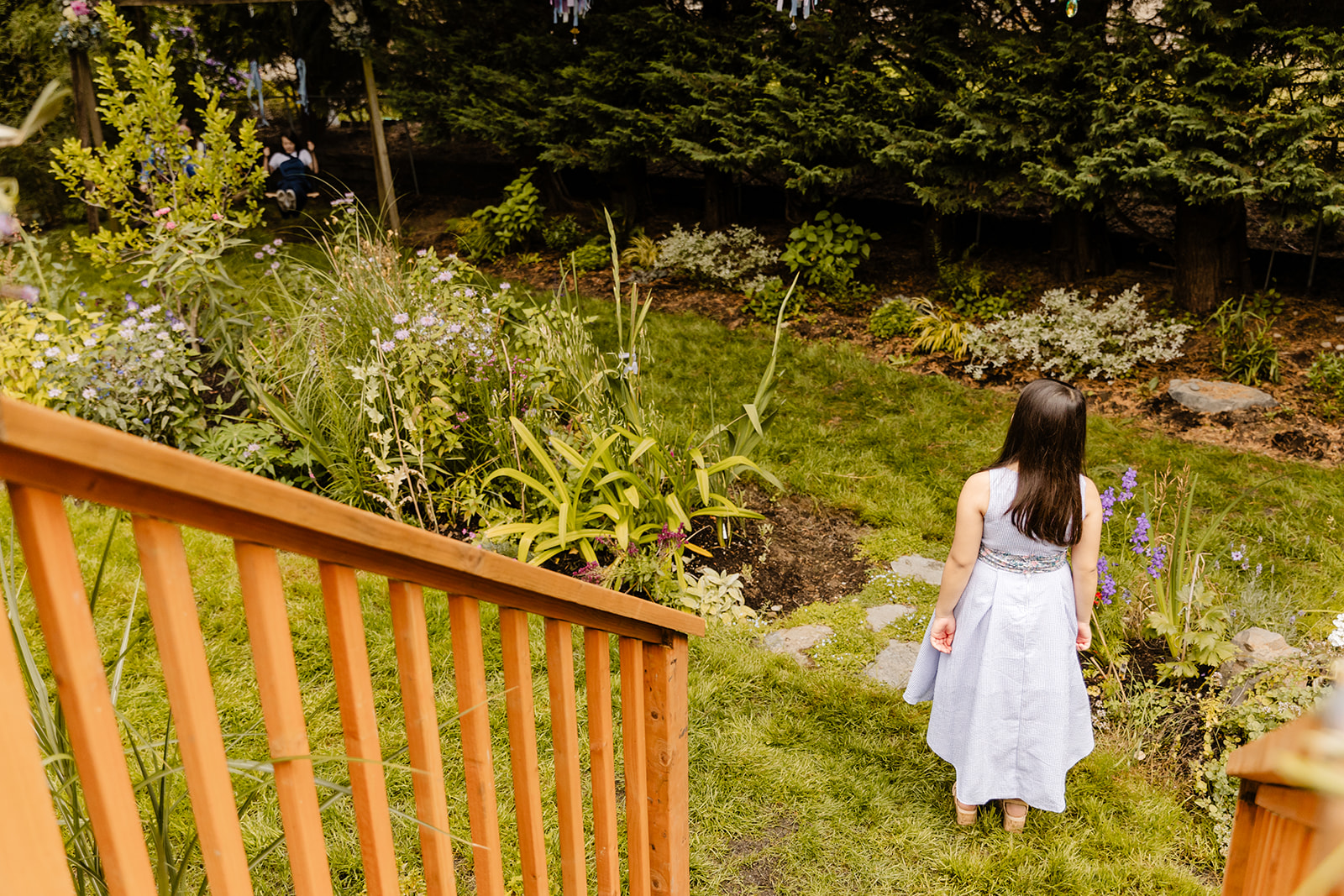 little girl walks through backyard
