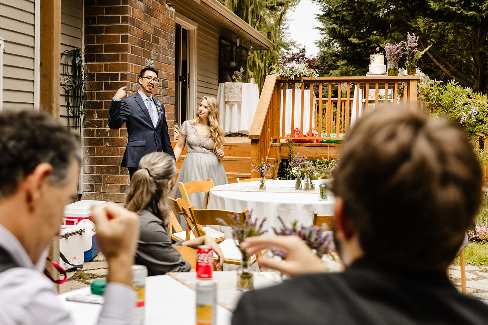 bride and groom enter a wedding in their backyard