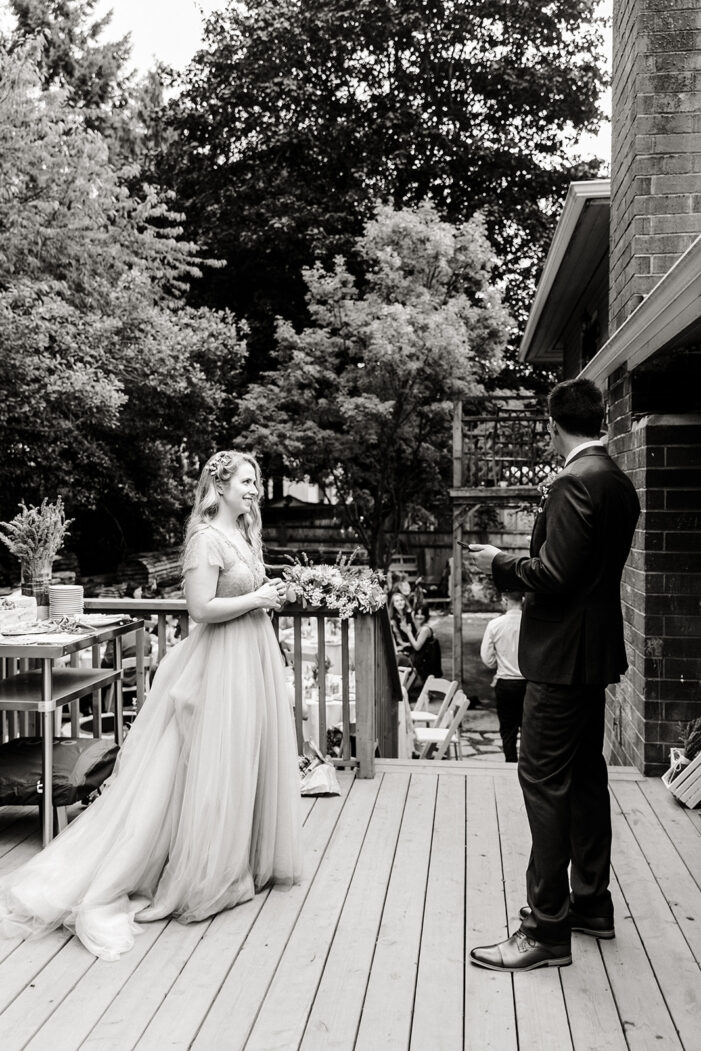 bride and groom dance on the porch in backyard wedding