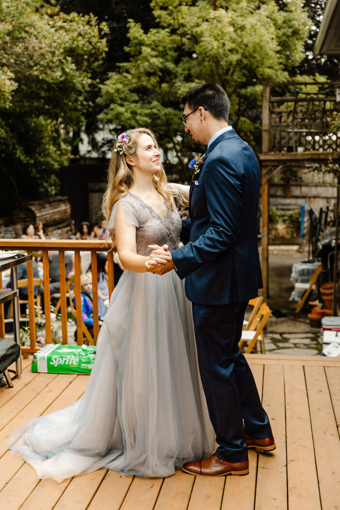 bride and groom dance on the porch in backyard wedding