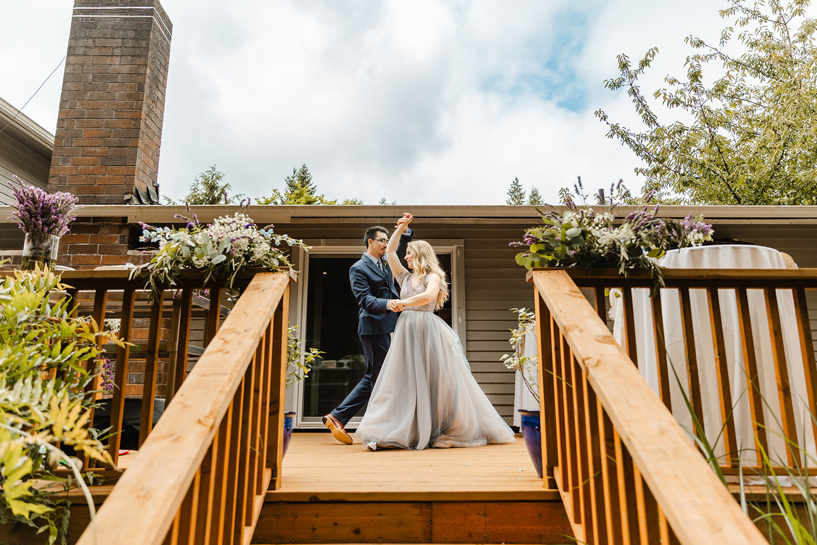 bride and groom dance on the porch in backyard wedding