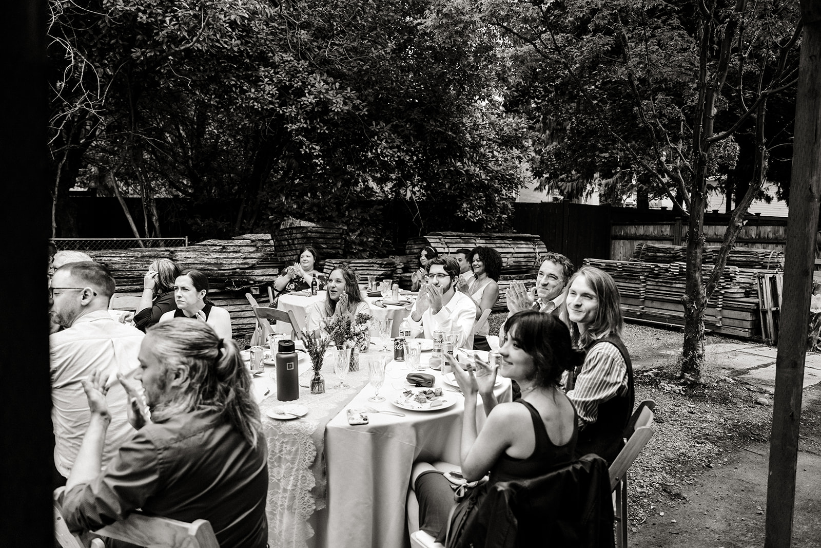 guests look on at bride and groom dancing on porch