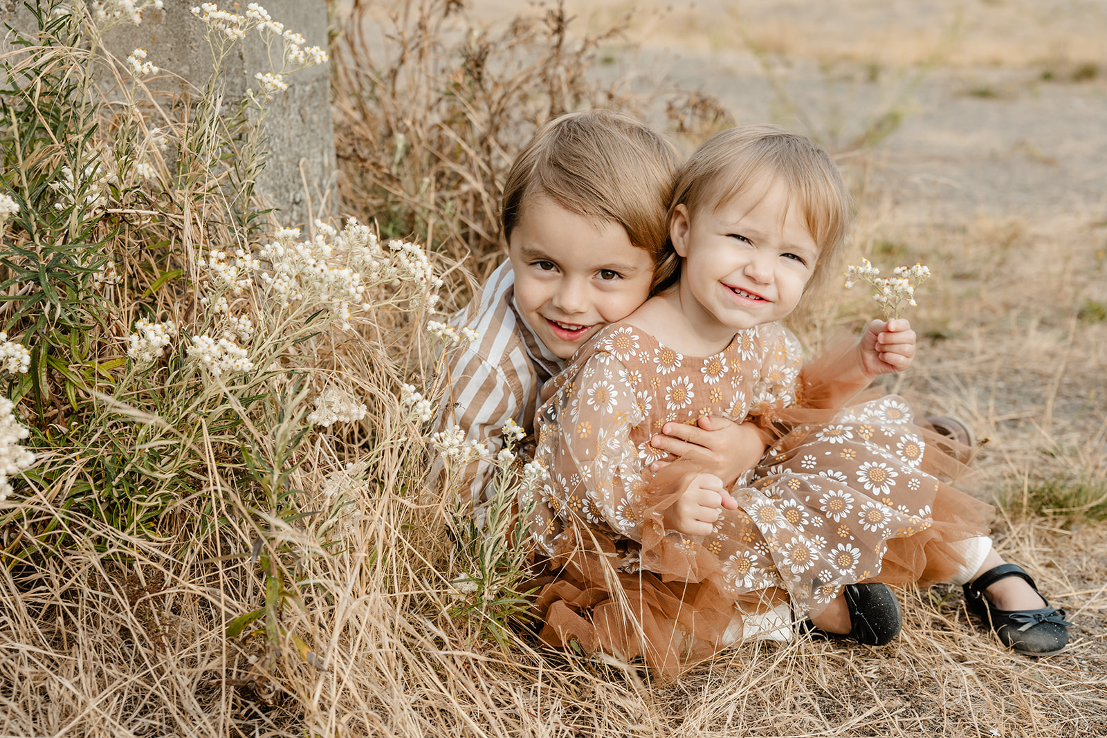 brother and sister smiling at camera during fall family photos, tacoma family photographer