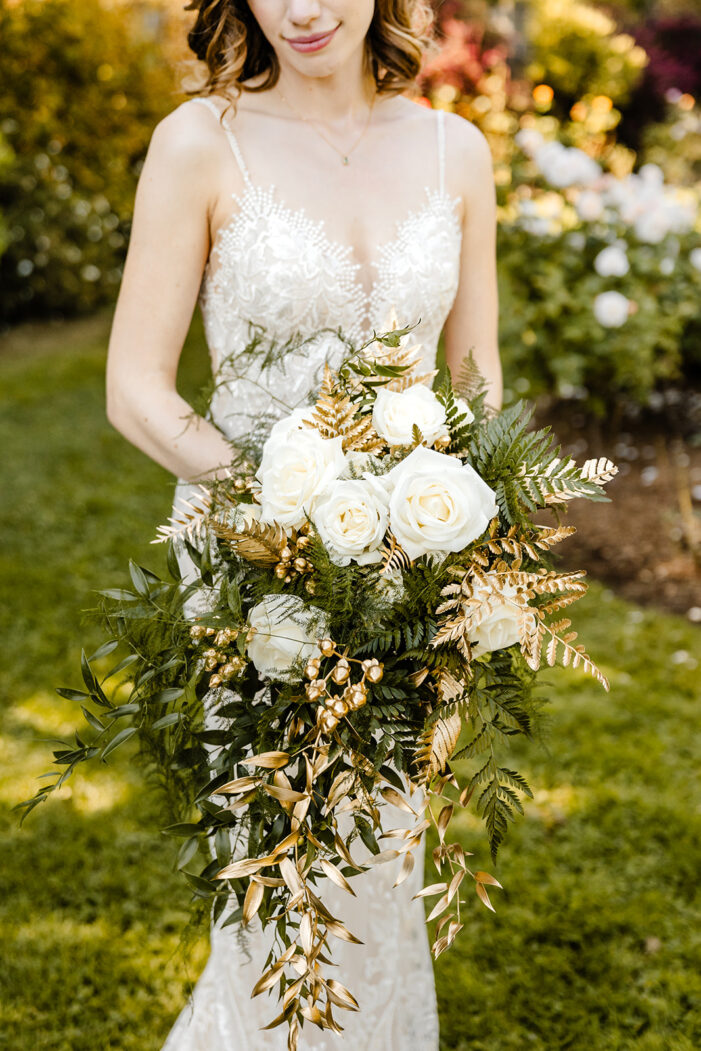 close on white and green bridal bouquet with gold accents