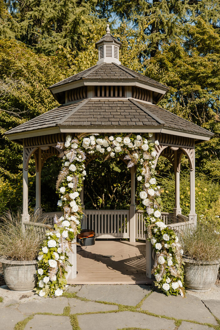 ceremony set up with white and green florals and gold accents