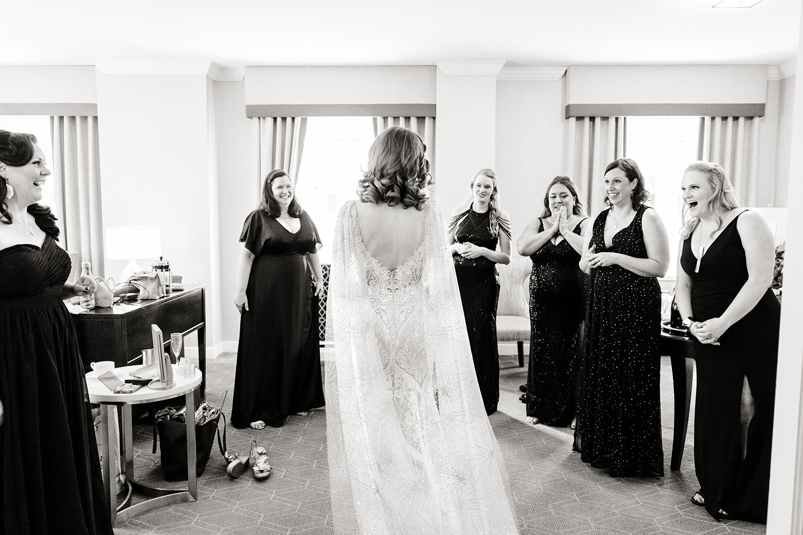 bride stands in front of bridemaids