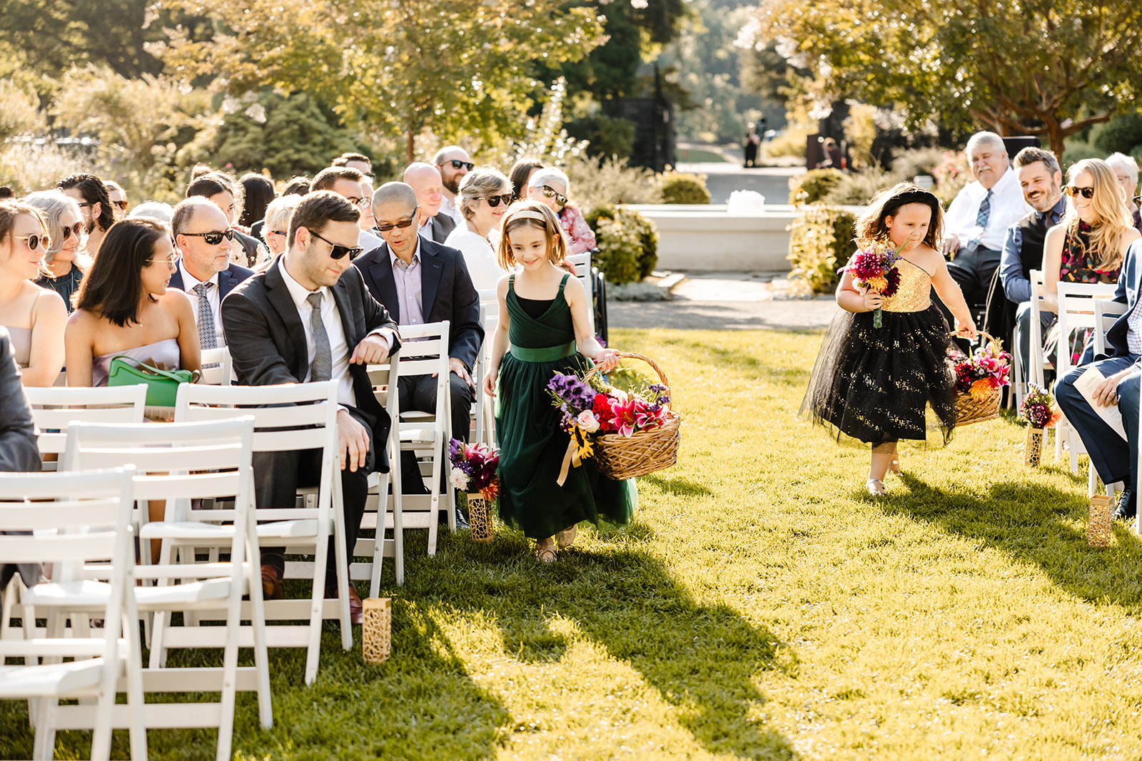 flower girls at ceremony putting bouquets into vases