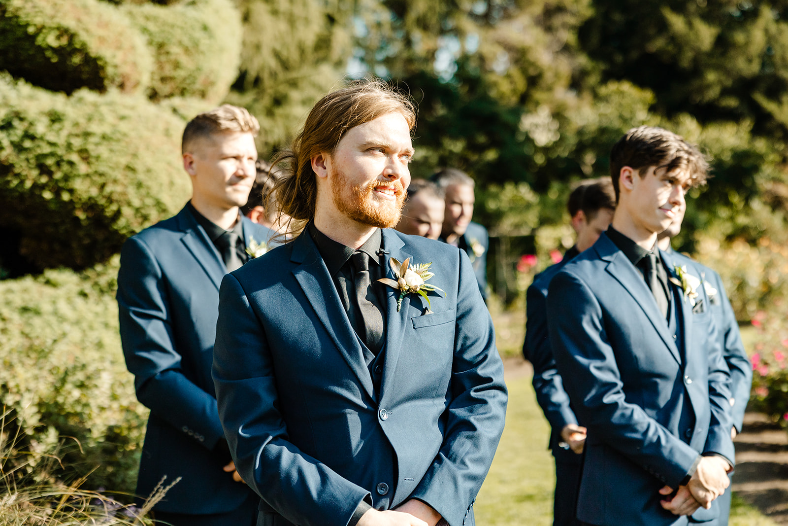 groom watches bride walk down aisle 