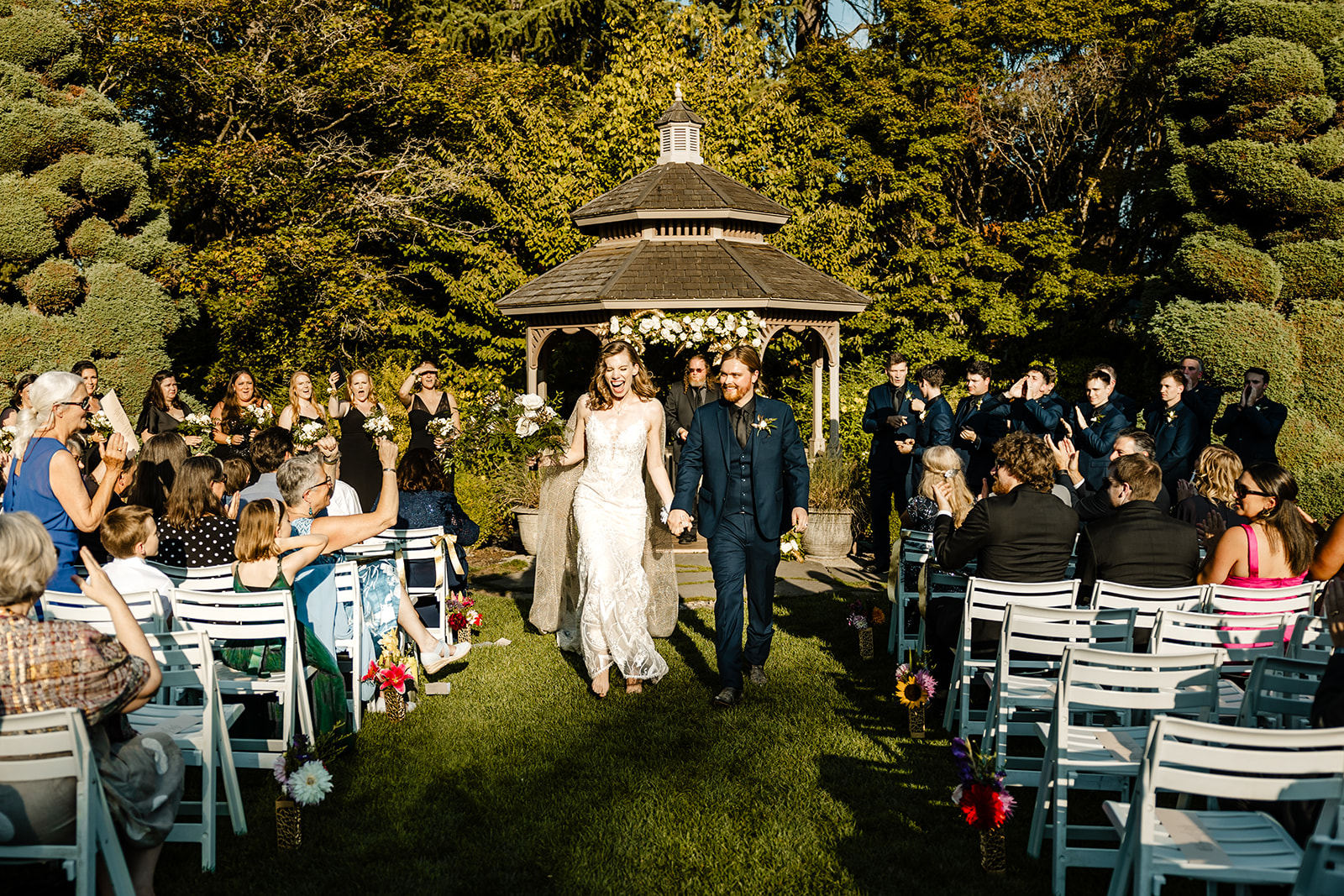 bride and groom walk back up aisle after wedding ceremony