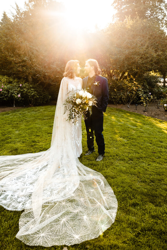 bride and groom face each other in pool of sunlight