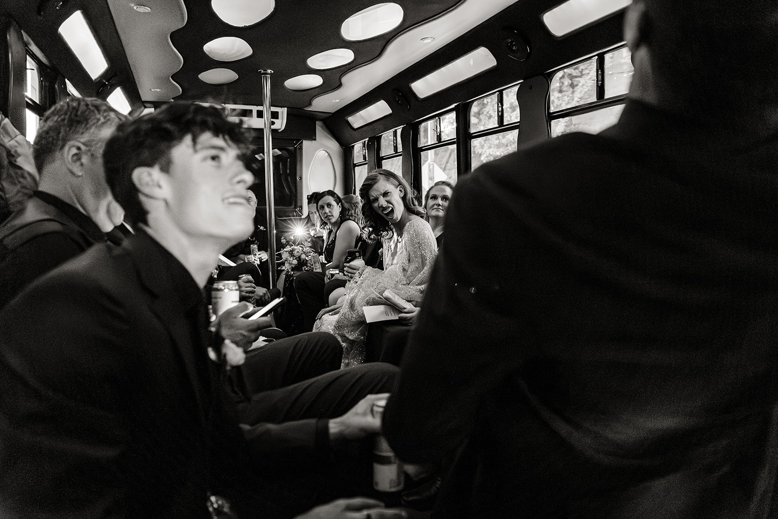 bride smiles broadly in party bus