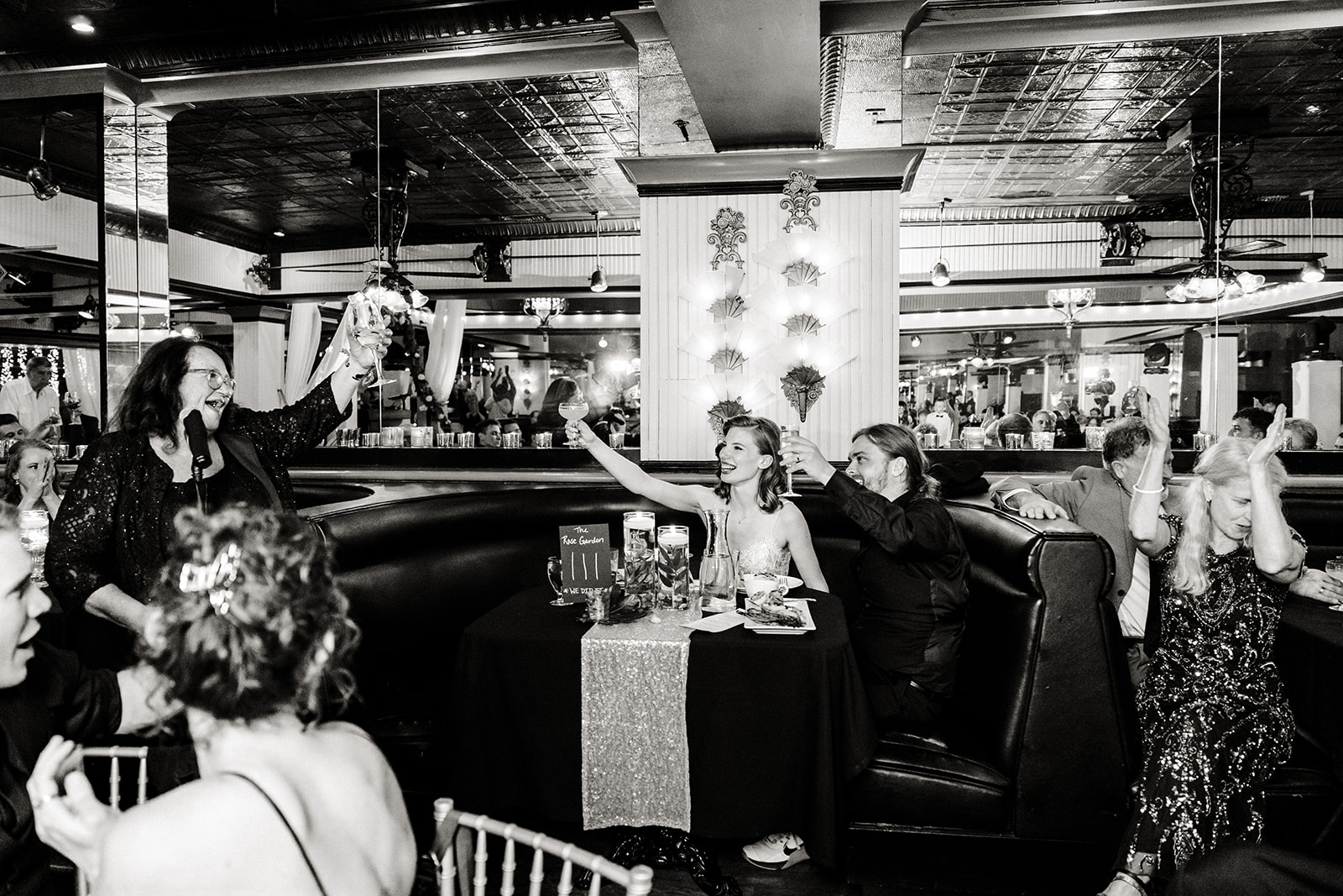 bride and groom cheers from their table