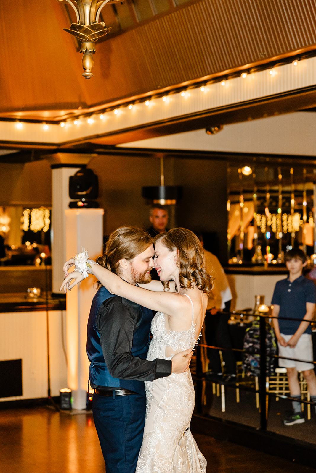 bride and groom dance with foreheads together
