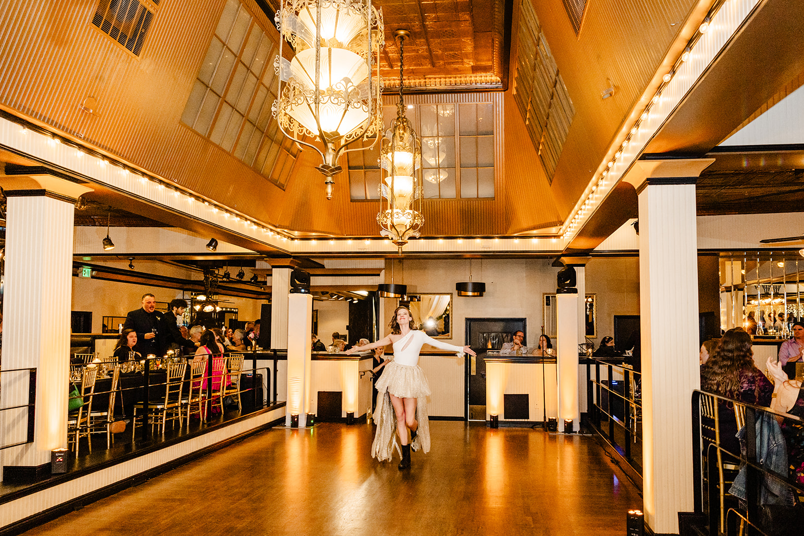 bride walks onto dance floor with wide arms