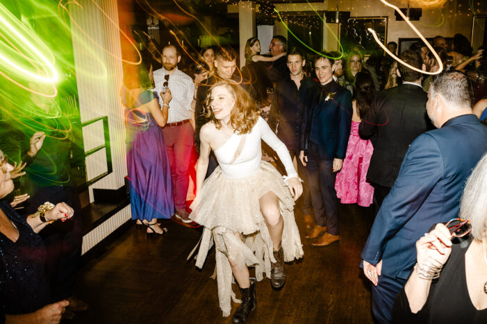 bride dances amongst wedding guests