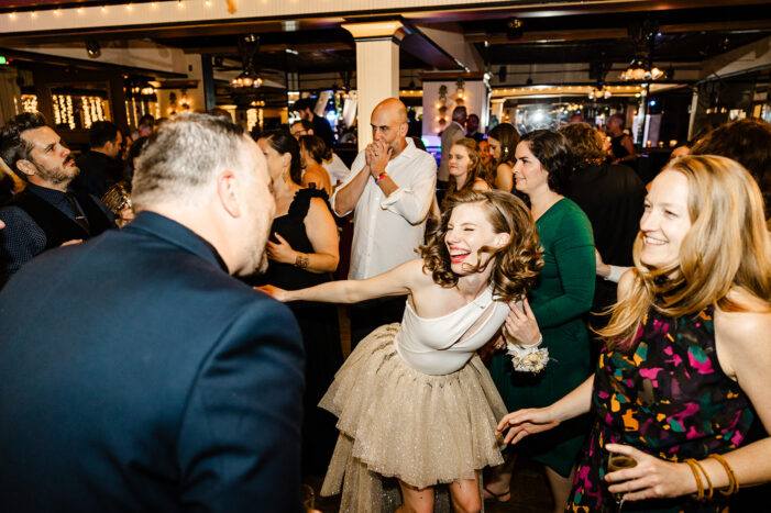 bride dances amongst wedding guests