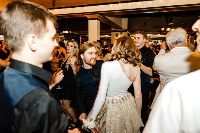bride dances amongst wedding guests