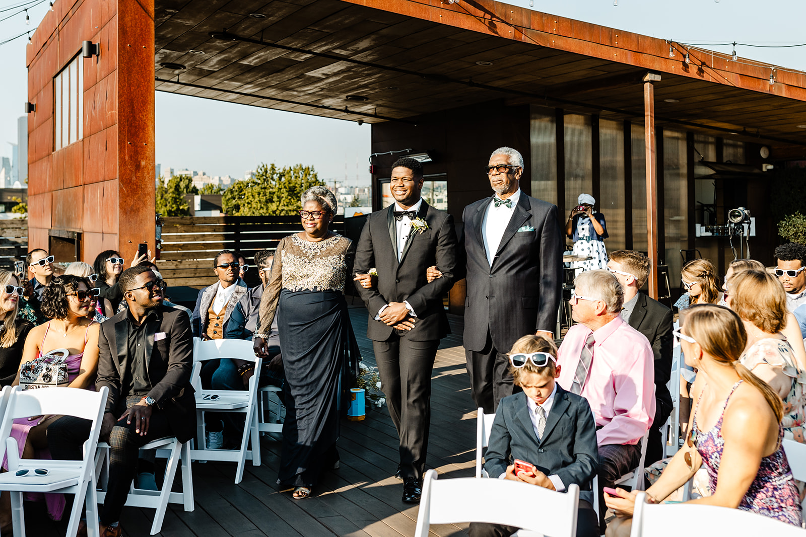 groom walks down aisle with parents at within sodo wedding venue