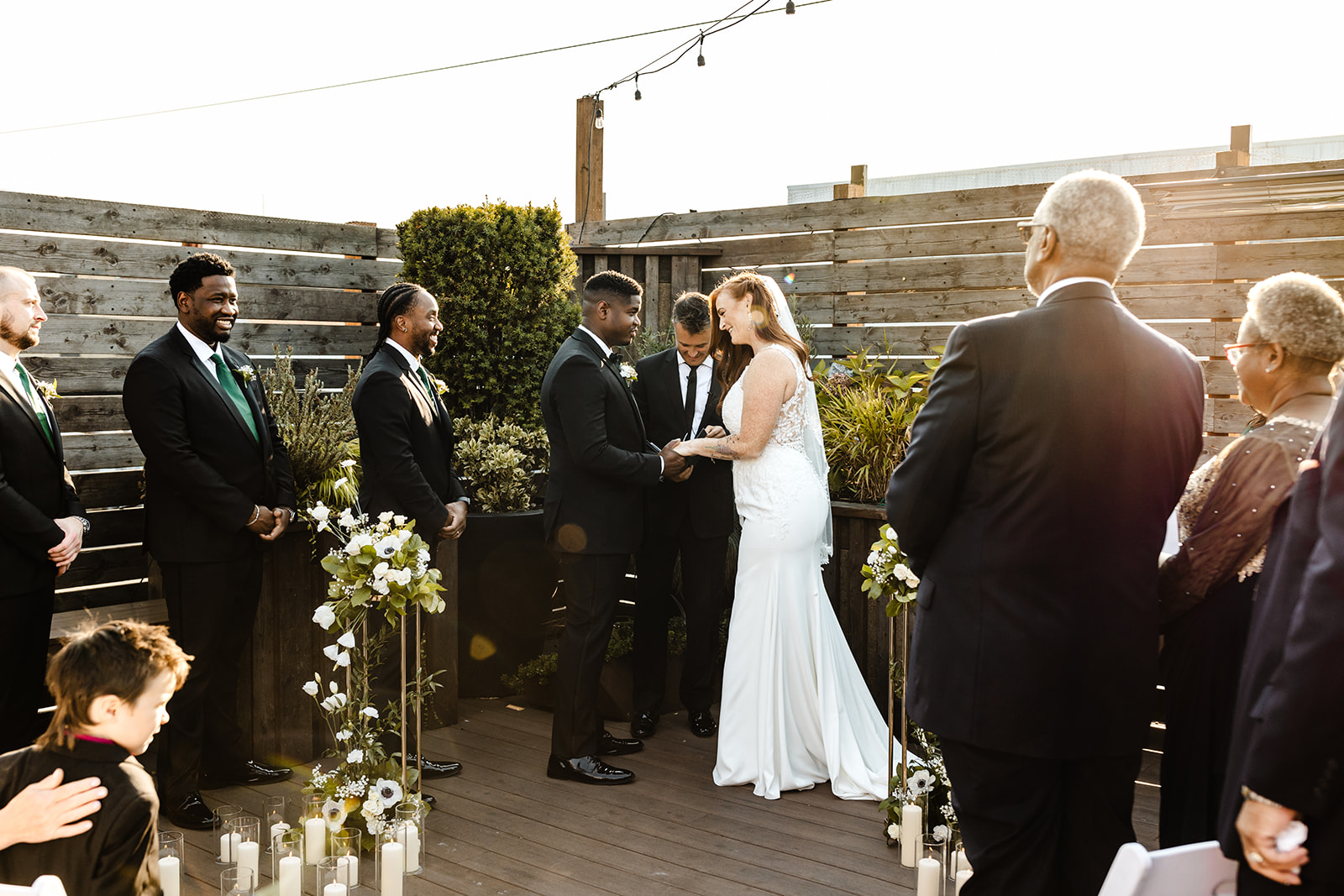 bride and groom stand at front of ceremony space at within sodo wedding venue