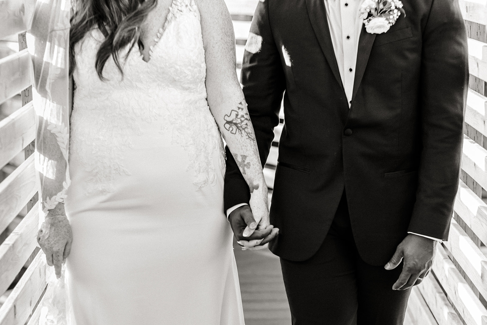 bride and groom hold hands and walk together