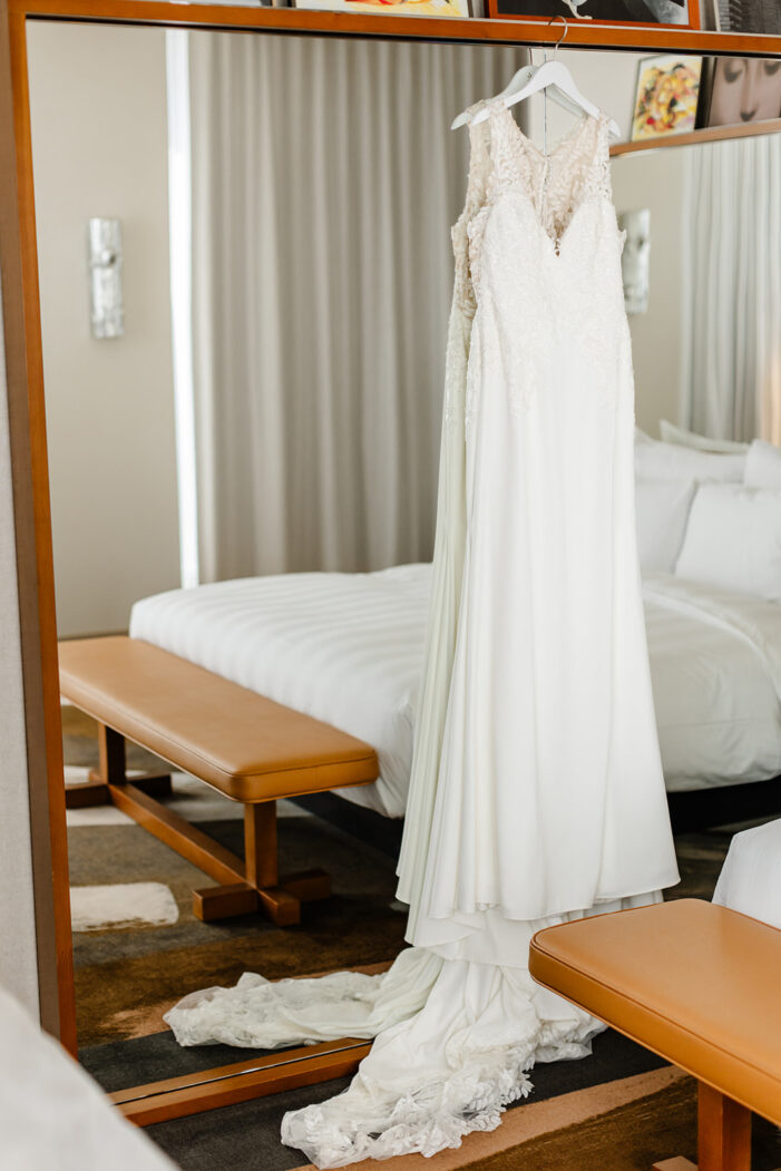 wedding dress hanging on mirror