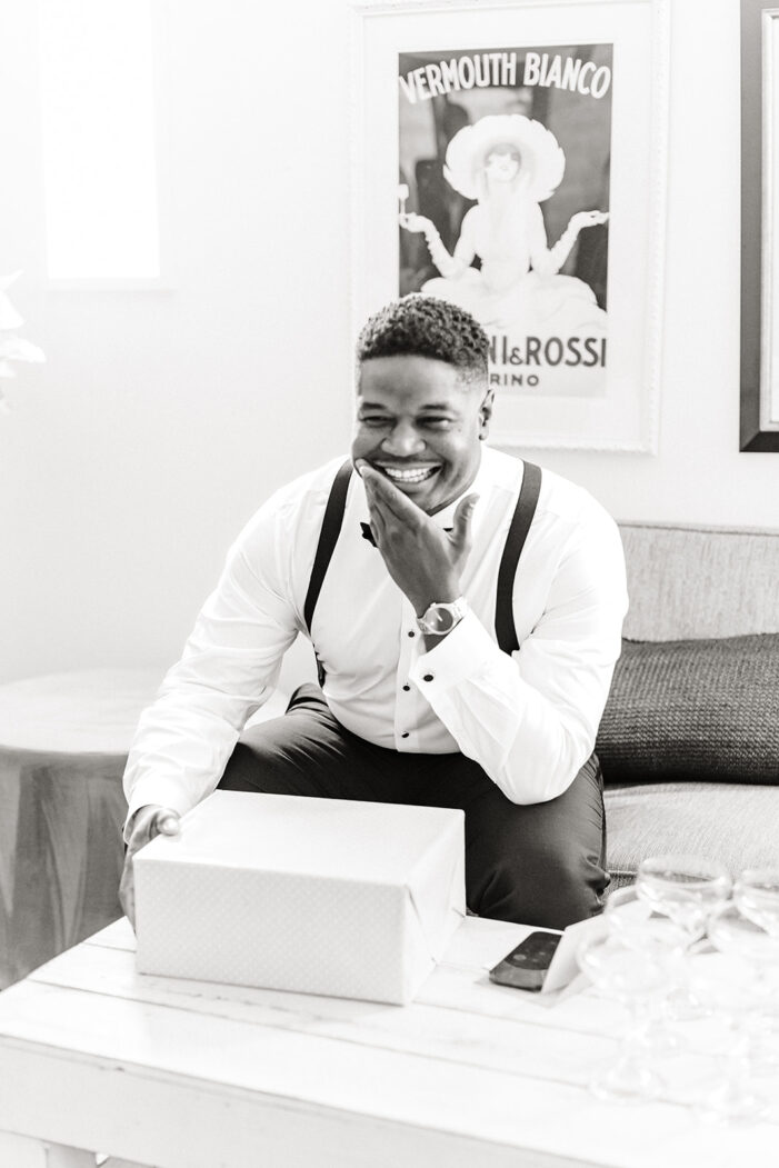 groom opens gift on wedding day