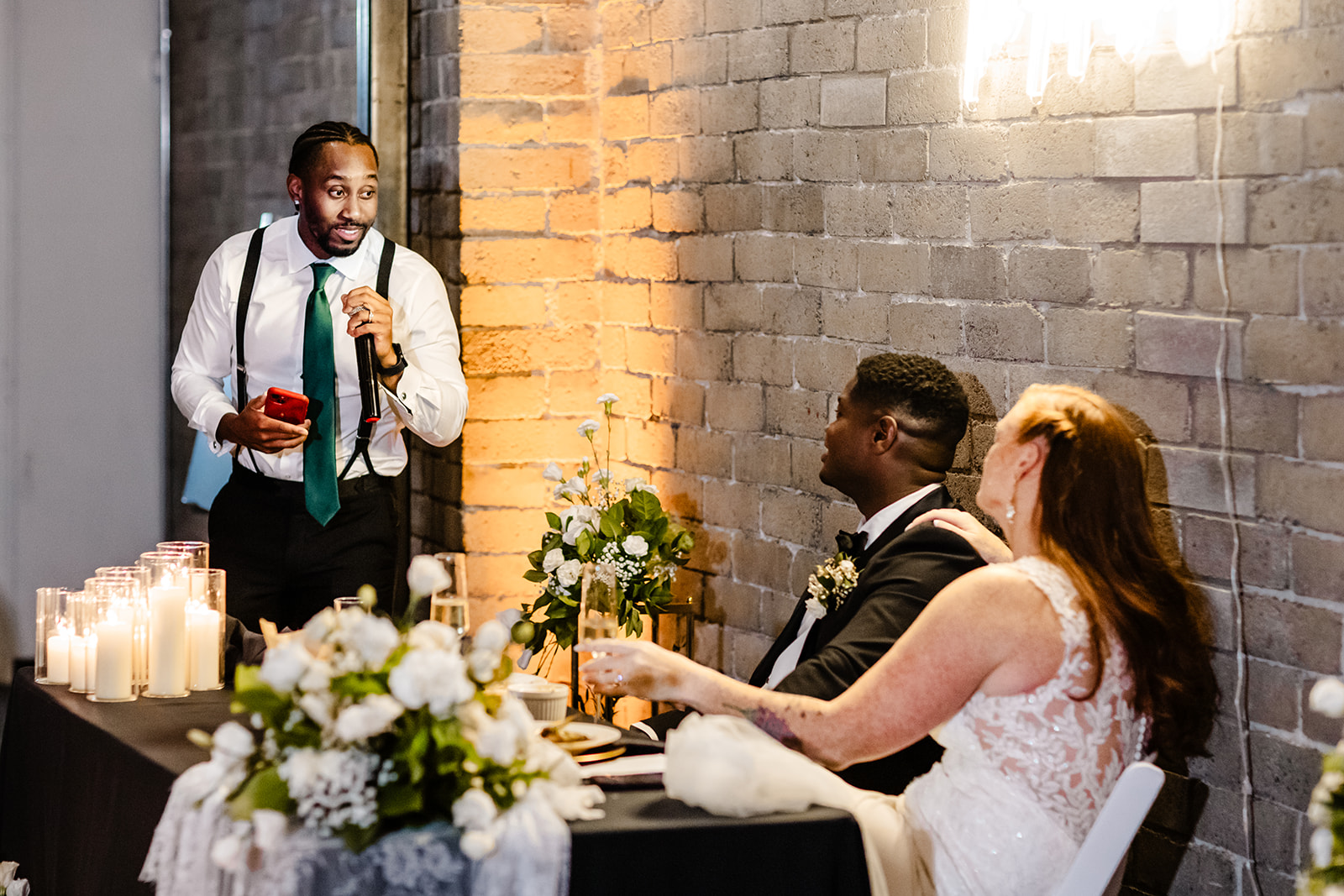 groomsman gives speech during wedding reception