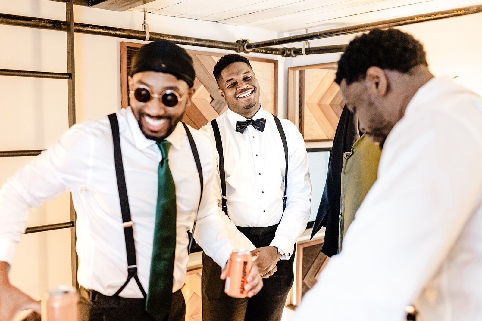groom laughs amongst his groomsmen