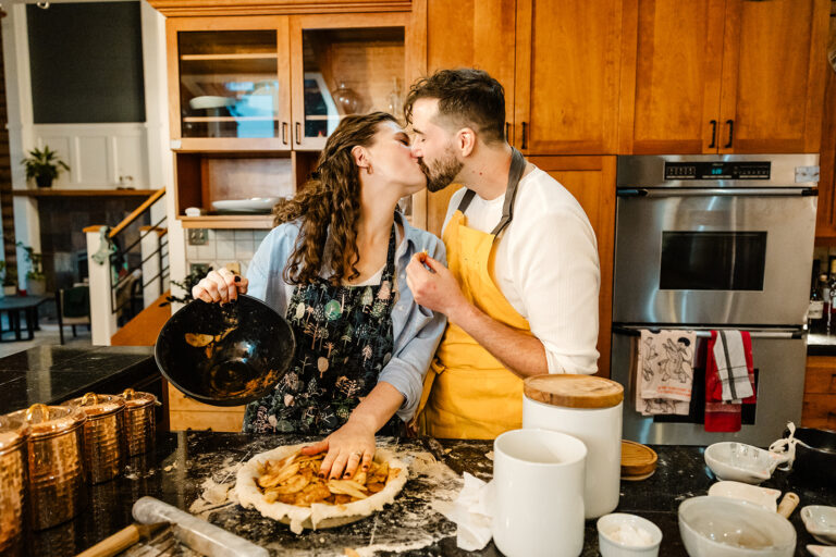 man and woman kiss in kitchen