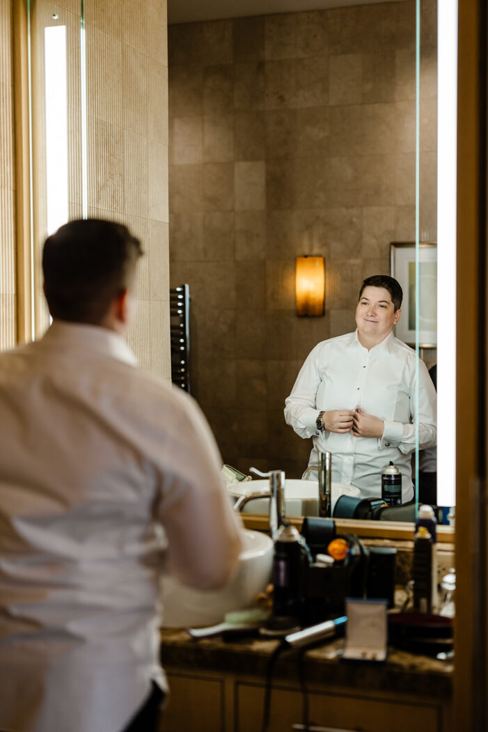 bride looks into mirror