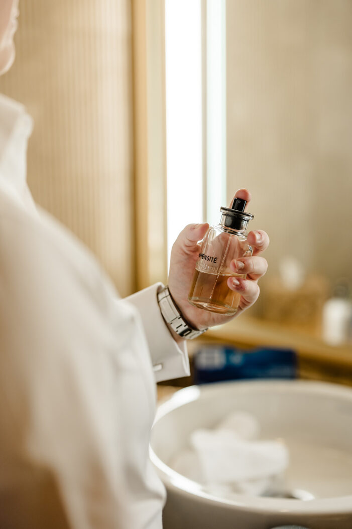 hand holding perfume