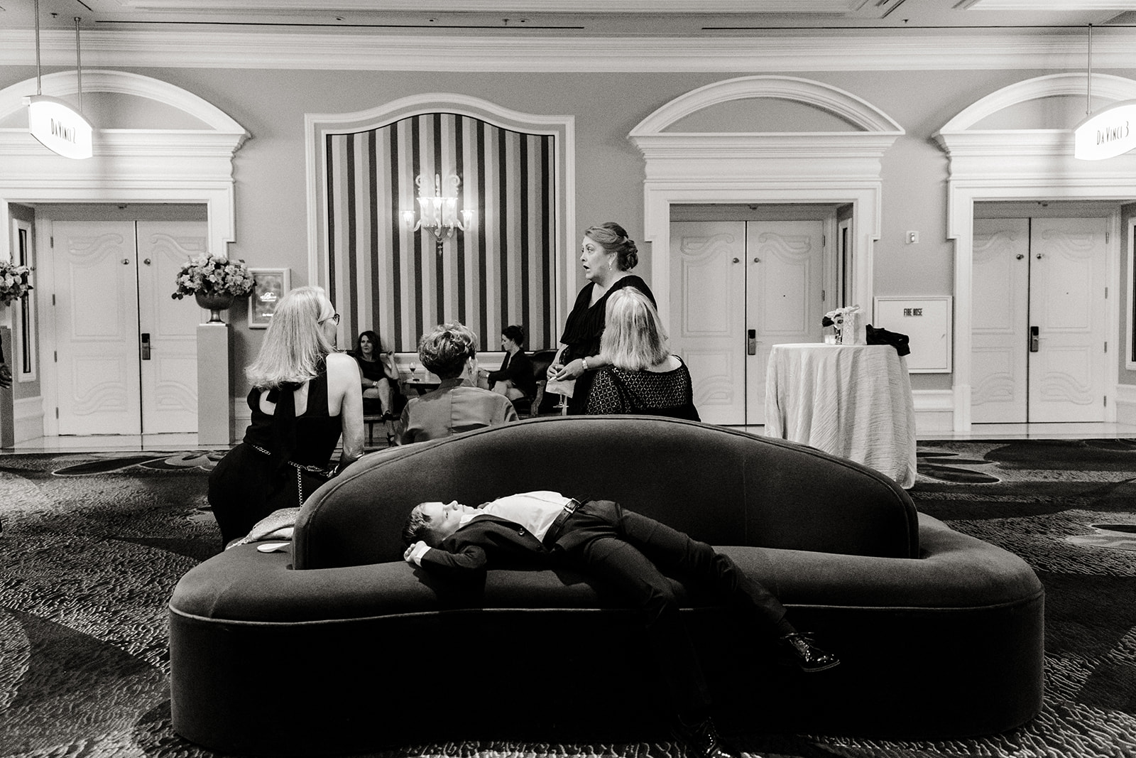boy lays on couch at wedding