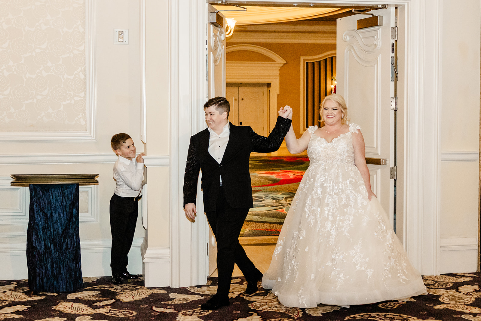 two brides walking into wedding reception