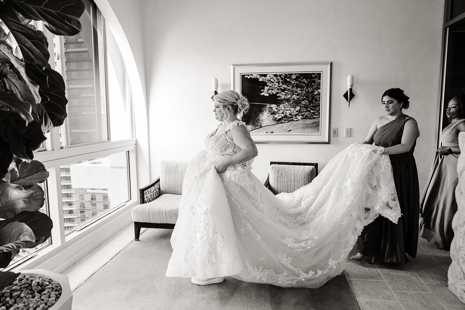 bride in ballgown walks towards window