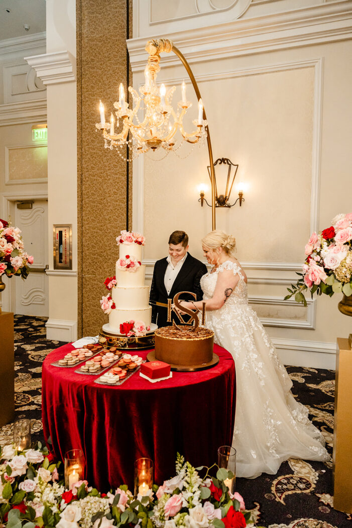 two brides cut cake at a vegas wedding