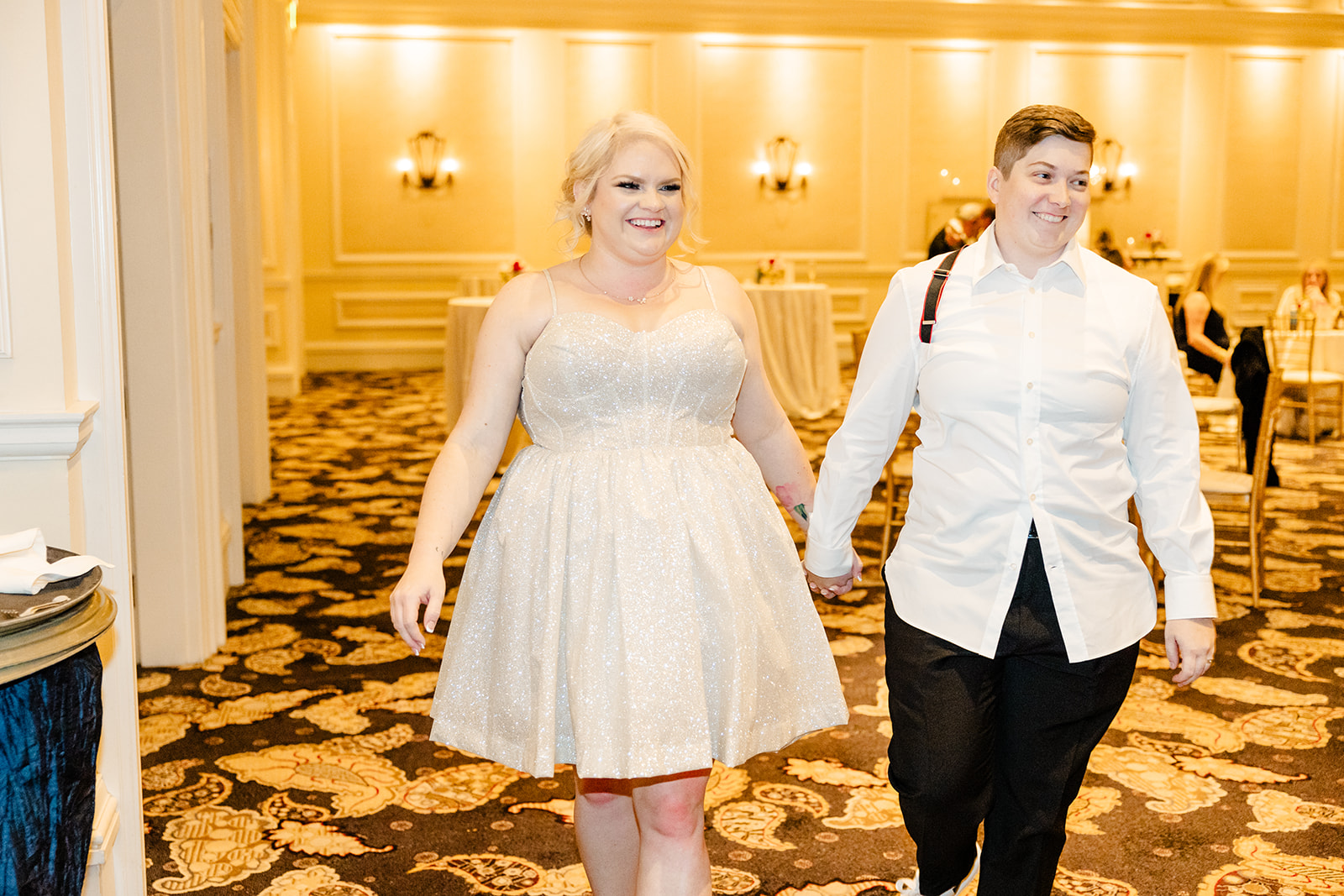 two brides, one of them in a short party dress