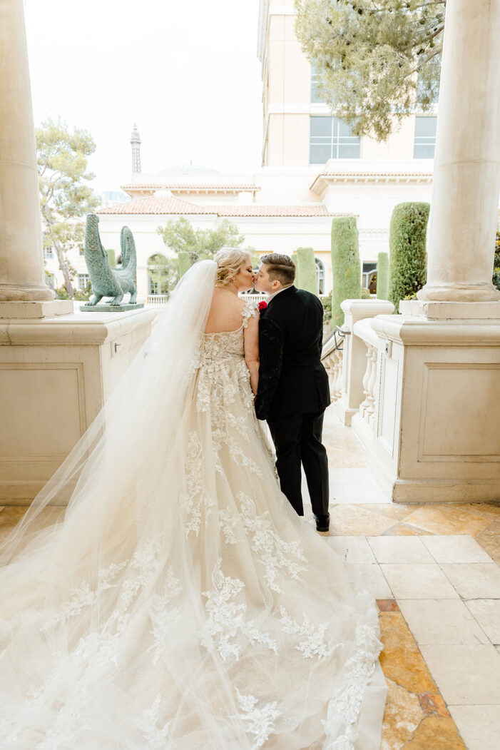 to brides kiss between pillars at vegas wedding