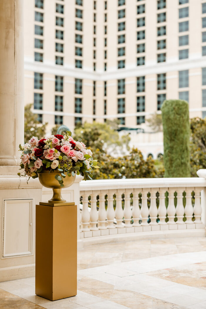 ceremony details at las vegas wedding with pink and red florals