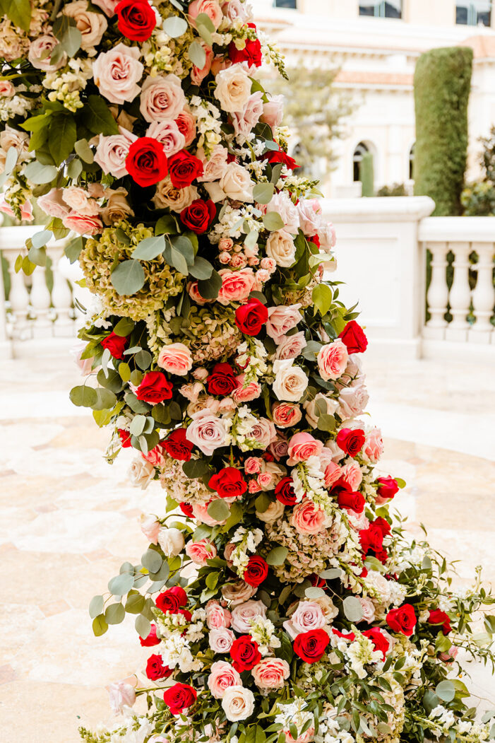 ceremony details at las vegas wedding with pink and red florals