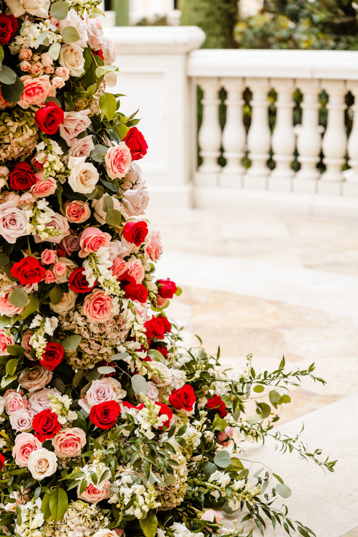 ceremony details at las vegas wedding with pink and red florals