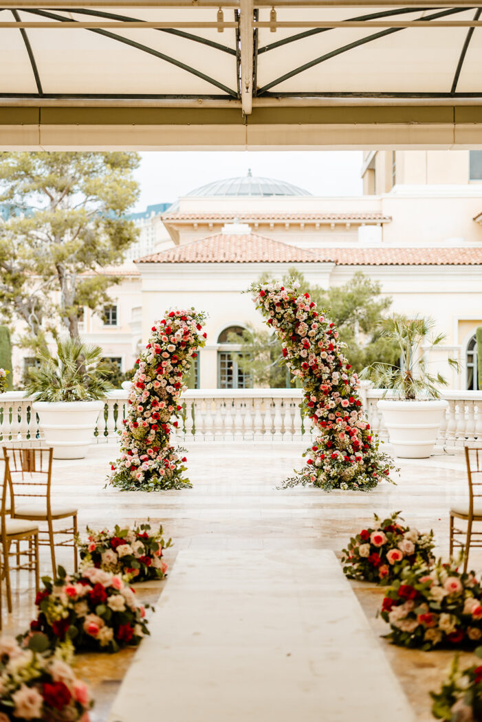 ceremony details at las vegas wedding with pink and red florals