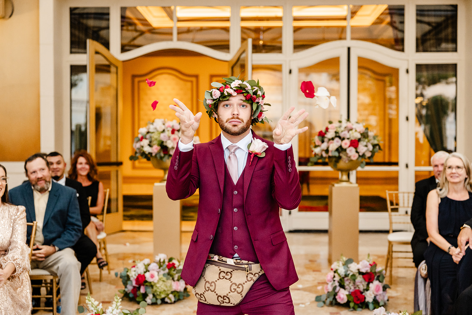 flower boy throws flowers from a fanny pack