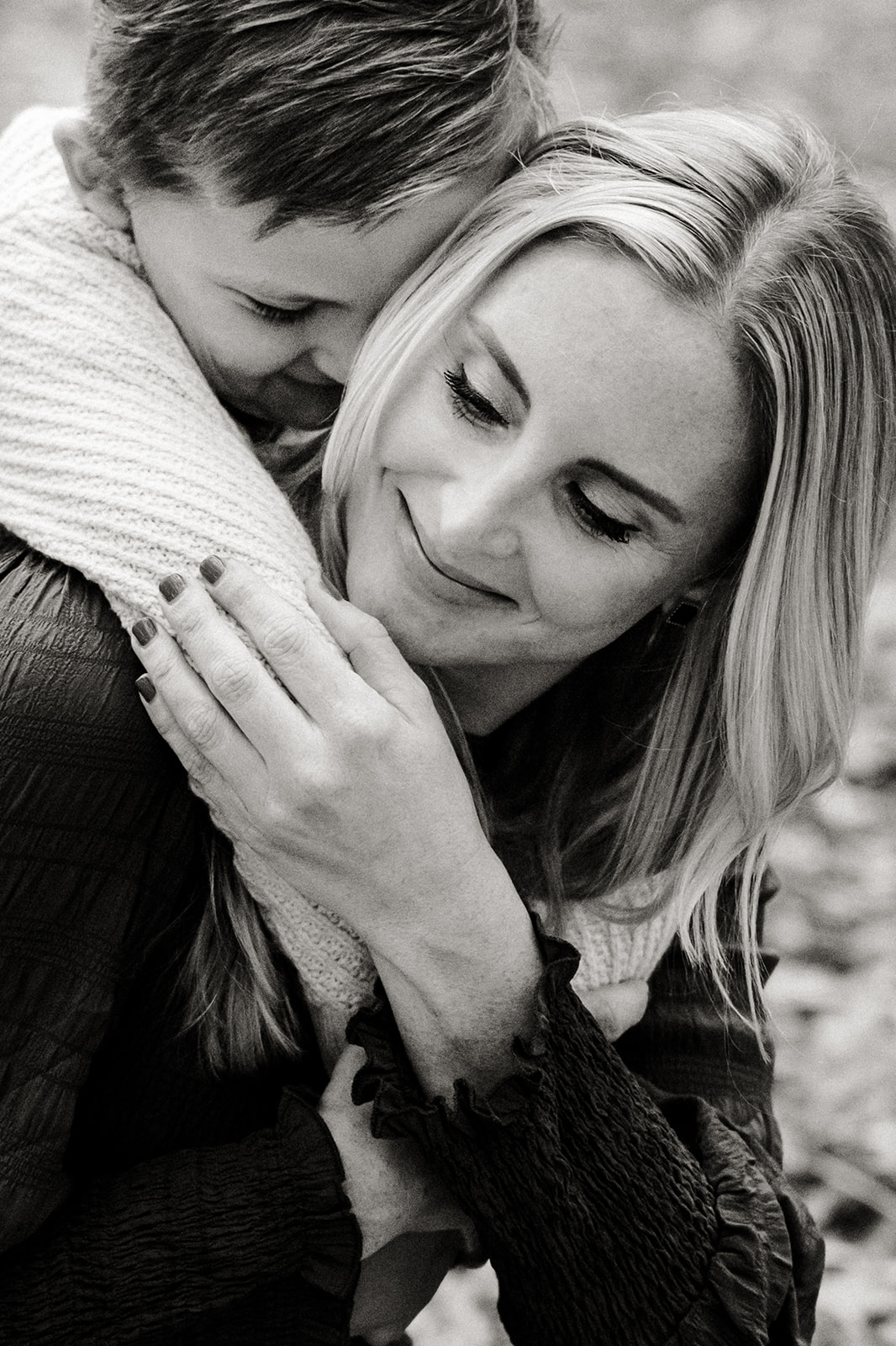 son giving mom a hug from behind, snuggle and candid pose family session pictures